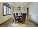 Elegant dining room features dark wood table and chandelier at 1777 W Ocotillo Rd # 2, Chandler, AZ 85248