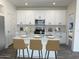 Modern kitchen with white cabinets and a kitchen island at 18118 W Sand Hills Dr, Surprise, AZ 85387