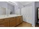 Main bathroom with double vanity sinks and a shower at 20948 N Sansom Dr, Maricopa, AZ 85138