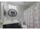 Bathroom with a single sink, shower, and decorative shower curtain at 20948 N Sansom Dr, Maricopa, AZ 85138