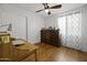 Bedroom with a dresser, desk, and ceiling fan at 20948 N Sansom Dr, Maricopa, AZ 85138