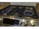 Close-up view of a gas cooktop with five burners at 20948 N Sansom Dr, Maricopa, AZ 85138