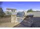 Built-in outdoor kitchen with a gas grill at 20948 N Sansom Dr, Maricopa, AZ 85138