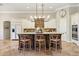 Island kitchen with granite counters, dark wood cabinets, and seating at 2179 E Cedar Pl, Chandler, AZ 85249