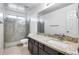 Bathroom with granite countertop, large mirror and shower at 225 N 236Th Ave, Buckeye, AZ 85396