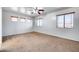 Spacious bedroom with ceiling fan and multiple windows at 225 N 236Th Ave, Buckeye, AZ 85396