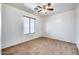 Simple bedroom with ceiling fan and window with blinds at 225 N 236Th Ave, Buckeye, AZ 85396