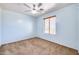 Light blue-walled bedroom with ceiling fan and window coverings at 225 N 236Th Ave, Buckeye, AZ 85396