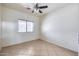 Simple bedroom with tile floors and ceiling fan at 225 N 236Th Ave, Buckeye, AZ 85396