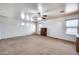 Spacious carpeted bedroom with ceiling fan and multiple windows at 225 N 236Th Ave, Buckeye, AZ 85396