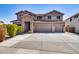 Two-story house with stone accents and a three-car garage at 225 N 236Th Ave, Buckeye, AZ 85396