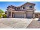 Two-story house with stone accents and a three-car garage at 225 N 236Th Ave, Buckeye, AZ 85396