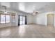 Gathering room with tile floors, sliding door to patio, and ceiling fan at 225 N 236Th Ave, Buckeye, AZ 85396