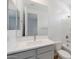 Modern bathroom with gray vanity, white countertop, and bathtub at 23070 E Starflower Dr, Queen Creek, AZ 85142