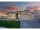 Single-story home with a two-car garage and landscaped front yard at 2319 E Williams Dr, Phoenix, AZ 85024