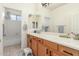 Clean bathroom with double vanity, large mirror, and tub shower combo at 2614 W Florimond Rd, Phoenix, AZ 85086