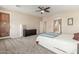 Spacious bedroom with carpeted floor, ceiling fan, and access to the bathroom at 2614 W Florimond Rd, Phoenix, AZ 85086