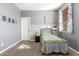 Bright bedroom with wood-look accent wall, twin bed, and window coverings at 2614 W Florimond Rd, Phoenix, AZ 85086