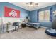Blue bedroom with built-in desk, twin bed, and ceiling fan at 2614 W Florimond Rd, Phoenix, AZ 85086