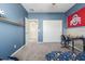 Bedroom with built-in desk and double door closet at 2614 W Florimond Rd, Phoenix, AZ 85086