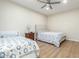 Bright bedroom with two beds, ceiling fan and hardwood floors at 2614 W Florimond Rd, Phoenix, AZ 85086