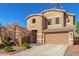 Two-story house with tan exterior, attached garage, and landscaping at 2614 W Florimond Rd, Phoenix, AZ 85086