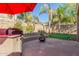 Stone patio with fire pit, grill, and putting green at 2614 W Florimond Rd, Phoenix, AZ 85086
