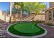 Landscaped backyard with a putting green at 2614 W Florimond Rd, Phoenix, AZ 85086