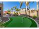 Backyard putting green surrounded by landscaping at 2614 W Florimond Rd, Phoenix, AZ 85086