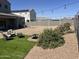 Backyard featuring gravel, artificial grass, desert landscaping, patio, and overhead string lights at 30770 W Mitchell Dr, Buckeye, AZ 85396