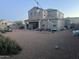 Large backyard area with gravel, patio seating, and string lights overhead at 30770 W Mitchell Dr, Buckeye, AZ 85396