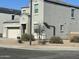 Two-story house with gray siding, attached garage, and desert landscaping at 30770 W Mitchell Dr, Buckeye, AZ 85396