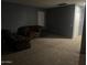 Cozy living room with carpet and a comfortable brown reclining sofa at 30770 W Mitchell Dr, Buckeye, AZ 85396