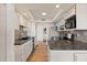 Modern kitchen with granite counters and white cabinets at 3110 W Paradise Dr, Phoenix, AZ 85029