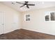 Bright bedroom with wood floors, ceiling fan, and ample closet space at 3215 E Captain Dreyfus Ave, Phoenix, AZ 85032