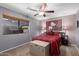 Guest bedroom with ceiling fan and large window at 3331 S Vine St, Chandler, AZ 85248