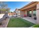 Landscaped backyard with patio and grass area at 3392 E Strawberry Dr, Gilbert, AZ 85298