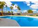 Refreshing swimming pool surrounded by a spacious patio and palm trees at 3502 W Ironwood Dr, Phoenix, AZ 85051