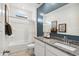 Bathroom with granite countertop, white cabinets, and a bathtub shower combo at 38130 W Bello Ln, Maricopa, AZ 85138