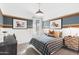 Charming bedroom with a plaid comforter and stylish wall decor at 38130 W Bello Ln, Maricopa, AZ 85138