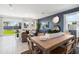 Bright dining area with wood table and access to backyard at 38130 W Bello Ln, Maricopa, AZ 85138