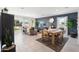 Bright dining area with a wooden table and access to backyard at 38130 W Bello Ln, Maricopa, AZ 85138