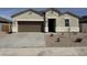 Charming single-story home with a two-car garage and neutral stucco exterior with decorative accents at 38130 W Bello Ln, Maricopa, AZ 85138