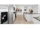 Kitchen with stainless steel refrigerator, granite counters and white cabinets at 38130 W Bello Ln, Maricopa, AZ 85138