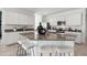 Kitchen with white cabinets, granite island, and stainless steel appliances at 38130 W Bello Ln, Maricopa, AZ 85138