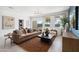 Bright and airy living room with large windows and a cozy atmosphere at 38130 W Bello Ln, Maricopa, AZ 85138
