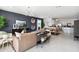 Open living room featuring a stylish sofa and a large TV at 38130 W Bello Ln, Maricopa, AZ 85138