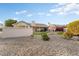 Landscaped backyard with gravel, artificial turf, and a block wall at 4037 N 155Th Dr, Goodyear, AZ 85395