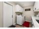 Laundry room with washer, dryer and white cabinets at 4037 N 155Th Dr, Goodyear, AZ 85395