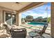 Relaxing covered patio with pool view at 4041 E Rakestraw Ln, Gilbert, AZ 85298